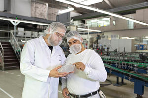 Marian Ferlic-Eisermann (left) checks a glass container with a colleague.